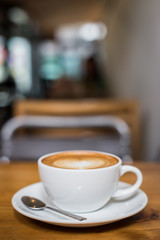 Hot art Latte Coffee in a cup on wooden table.