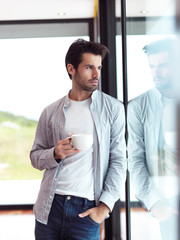 relaxed young man drink first morning coffee