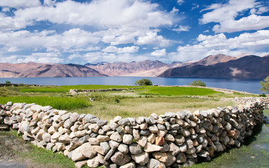 Pangong Lake in Ladakh, North India. Pangong Tso is an endorheic lake in the Himalayas situated at a height of about 4,350 m. It is 134 km long and extends from India to Tibet