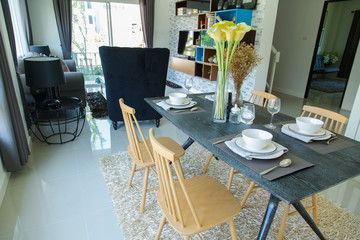 Dining table with set in modern home, Wooden table in Dining room, Luxury corner in the family. modern home designed, modern life in modern home, creative home designed, beautiful interior design.