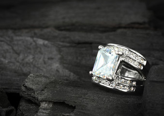 jewelry ring witht big brilliant on dark coal background