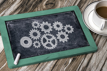 business concept: gears hand drawn on chalkboard