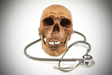 Medical concept, weathered human skull and stethoscope