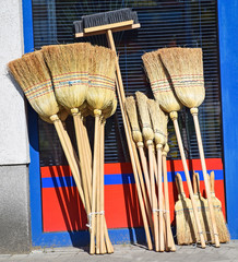 Brooms next to a shop