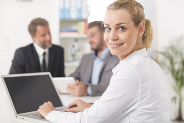 Smiling attratives businesswoman attending meeting