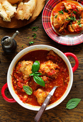 Baked rabbit in tomato sauce with rosemary and basil. Italian Cuisine.