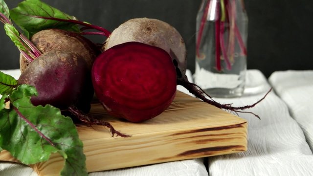 Beetroots on white painted rustic wooden table with slate background.
