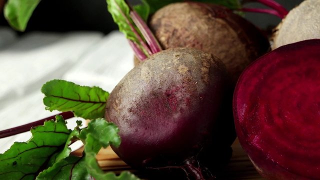 Beetroots on white painted rustic wooden table with slate background.