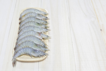 Fresh shrimp prepare for cook on wooden dish and wooden backgrou