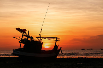 Fototapeta premium Sunsets and siluate boat