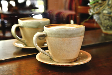 Cappuccino Coffee on Wooden table background