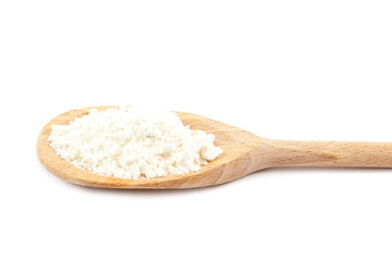 Fototapeta na wymiar Flour in a wooden spoon on a white background.