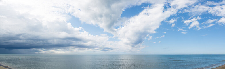 Naklejka na ściany i meble Blue sea and clouds