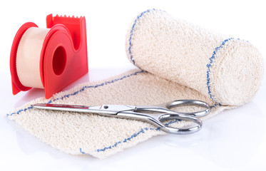 Medical bandage with scissors and sticking plaster