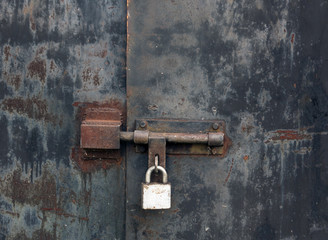 Old rusty locked metal gate.