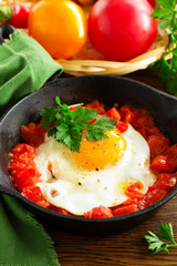 Scrambled eggs with roasted tomatoes.