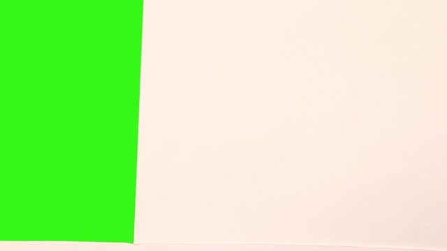 opening paper into green screen