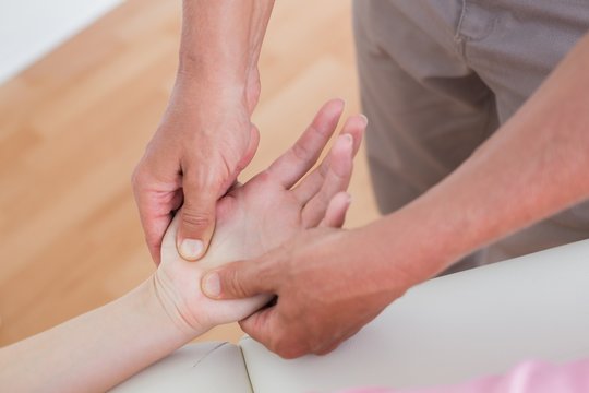 Physiotherapist doing hand massage 