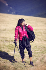 Fototapeta na wymiar Woman Traveler with Backpack hiking in Mountains with beautiful