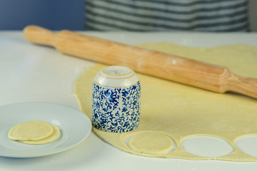 Man hands making dumplings with meat
