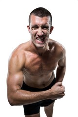 Fototapeta na wymiar Excited shirtless athlete flexing muscles