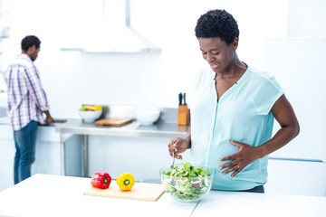 Woman having salad while standing 