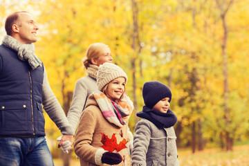 Fototapeta na wymiar happy family in autumn park