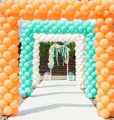 Balloon and paper arches like decorations for wedding ceremony in orange and blue colors - 91124853