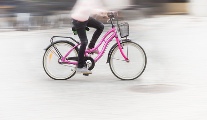 Young girl on pink bike