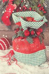  Christmas gift sack tied with ribbon, berries and holly leaves