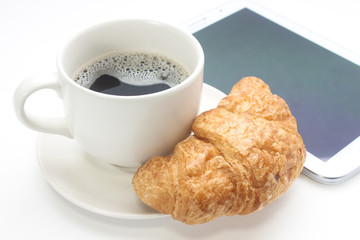 Coffee cup with a croissant isolated