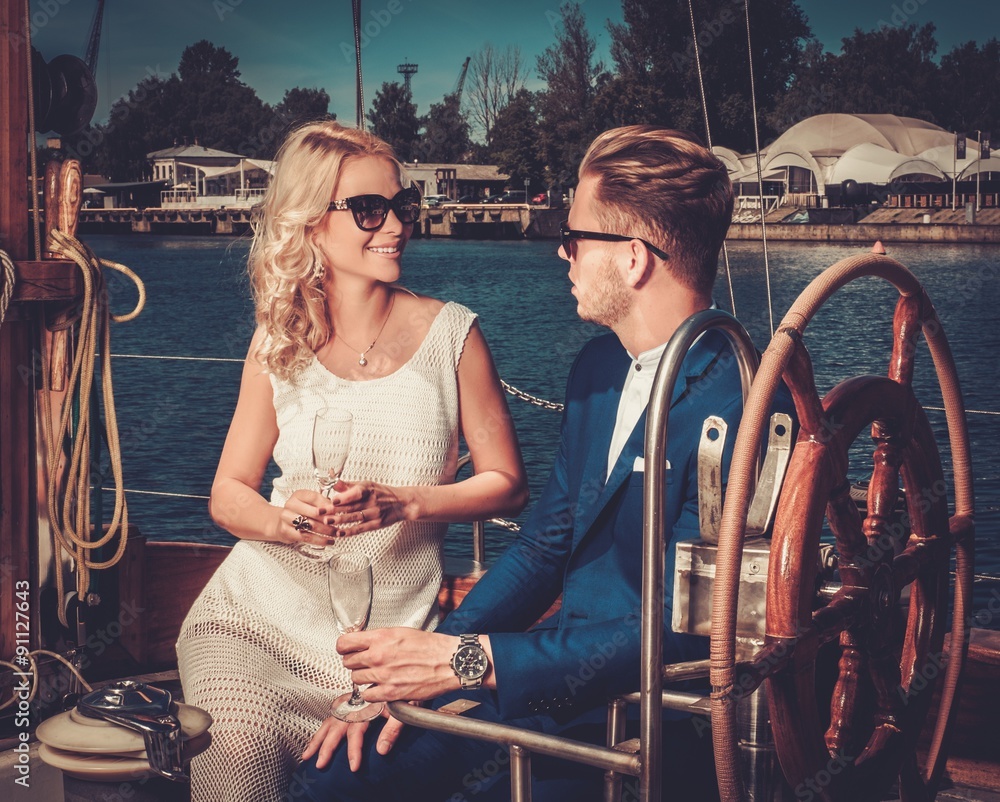 Wall mural Stylish wealthy couple on a luxury yacht