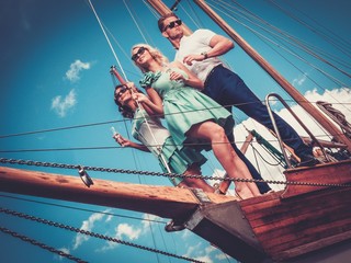 Stylish wealthy friends having fun on a luxury yacht
