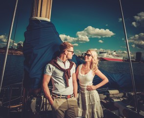 Stylish wealthy couple on a yacht
