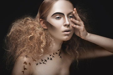 Beautiful girl with a pattern on the body in form of birds