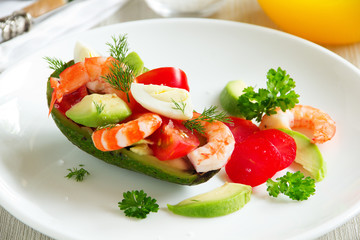 Avocado salad with shrimp and quail eggs.