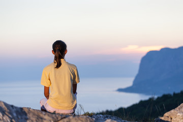 Woman on mountain looking at sunrise