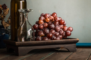 Grapes on wooden tray.