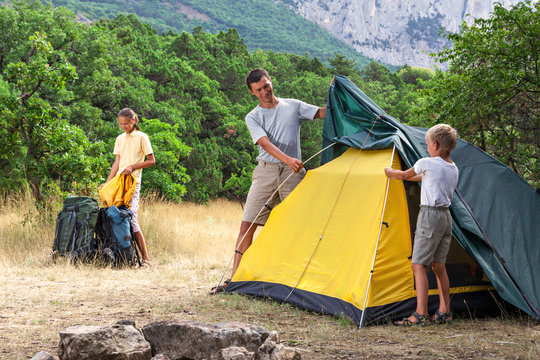 Father with children setting  tent