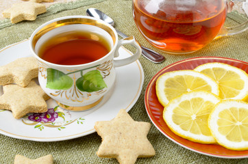 Homemade star cookies with tea and lemon