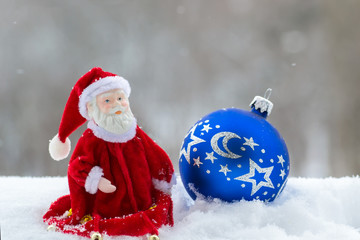 Santa Claus and blue shiny Christmas ball