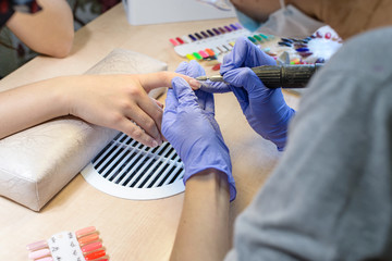 closeup of the hands of a young woman receiving the nail file by