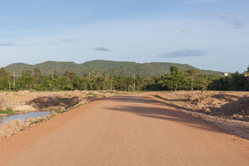 Dry countryside soil road in sunny day