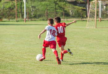 Boys kicking football