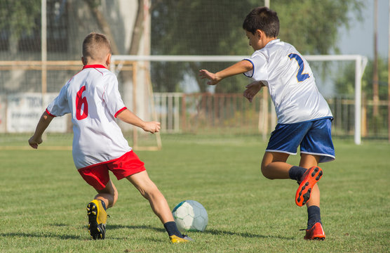 Boys kicking football