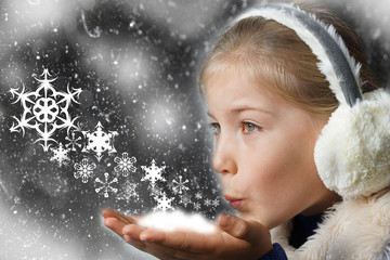 Christmas girl blowing snow