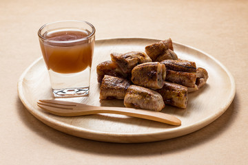 Thai snack grilled banana serve with coconut syrup