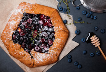 Rustic berry galette with blueberries and honey