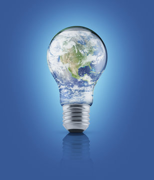 Earth globe in light bulb on blue background, Energy conservatio