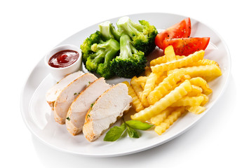 Grilled chicken fillet and vegetables on white background 
